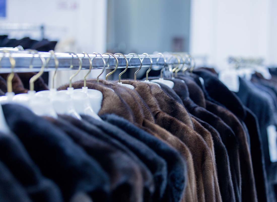 Furrier and Garment Insurance - Close-up of Luxury Fur Coats on Display at a Small Garment Dealer Boutique