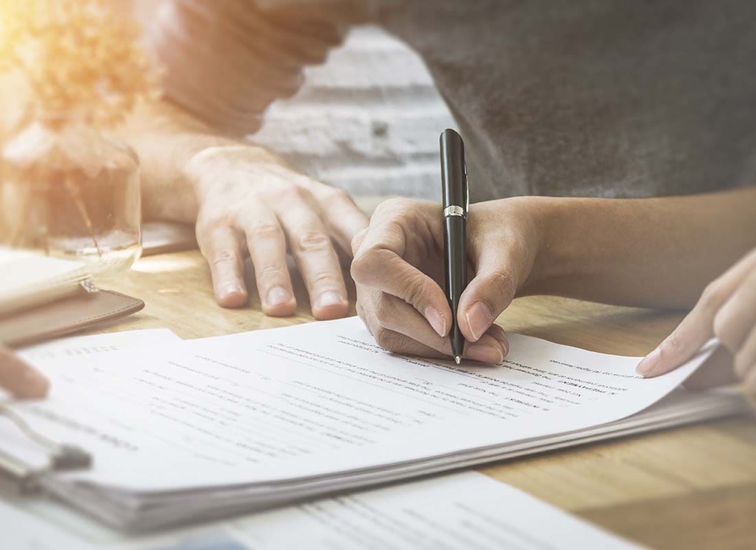 Probate Bond - Close-up of a Woman Giving Her Signature for a Business and Financial Contract In the Office of an Insurance Agent